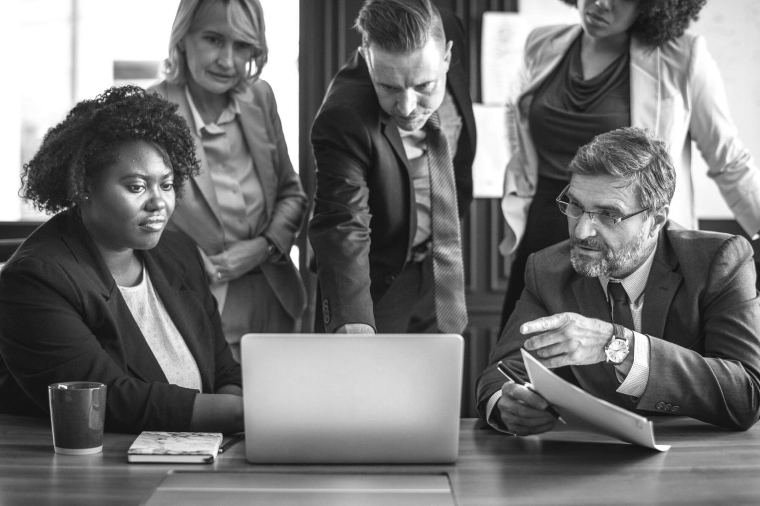 Professional financial consultation meeting with documents and planning materials on a modern conference table